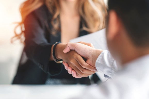 Close-up of a professional handshake symbolizing partnership and trust, highlighting the value of collaborating with a Managed Service Provider.